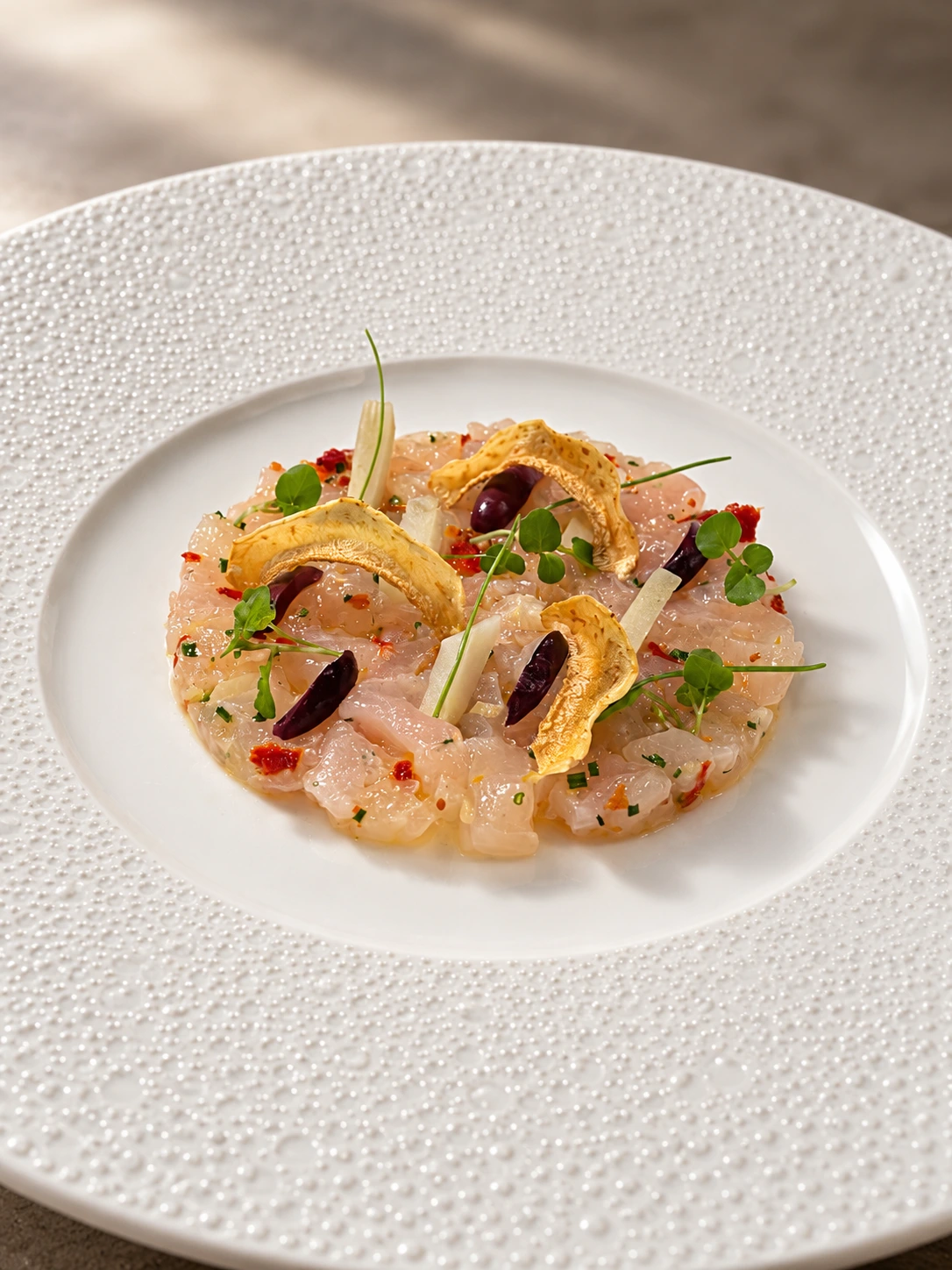 Tartare de poisson, jeunes pousses et chips